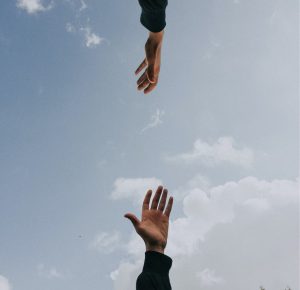 hand reaching for each other - Karuna Counselling